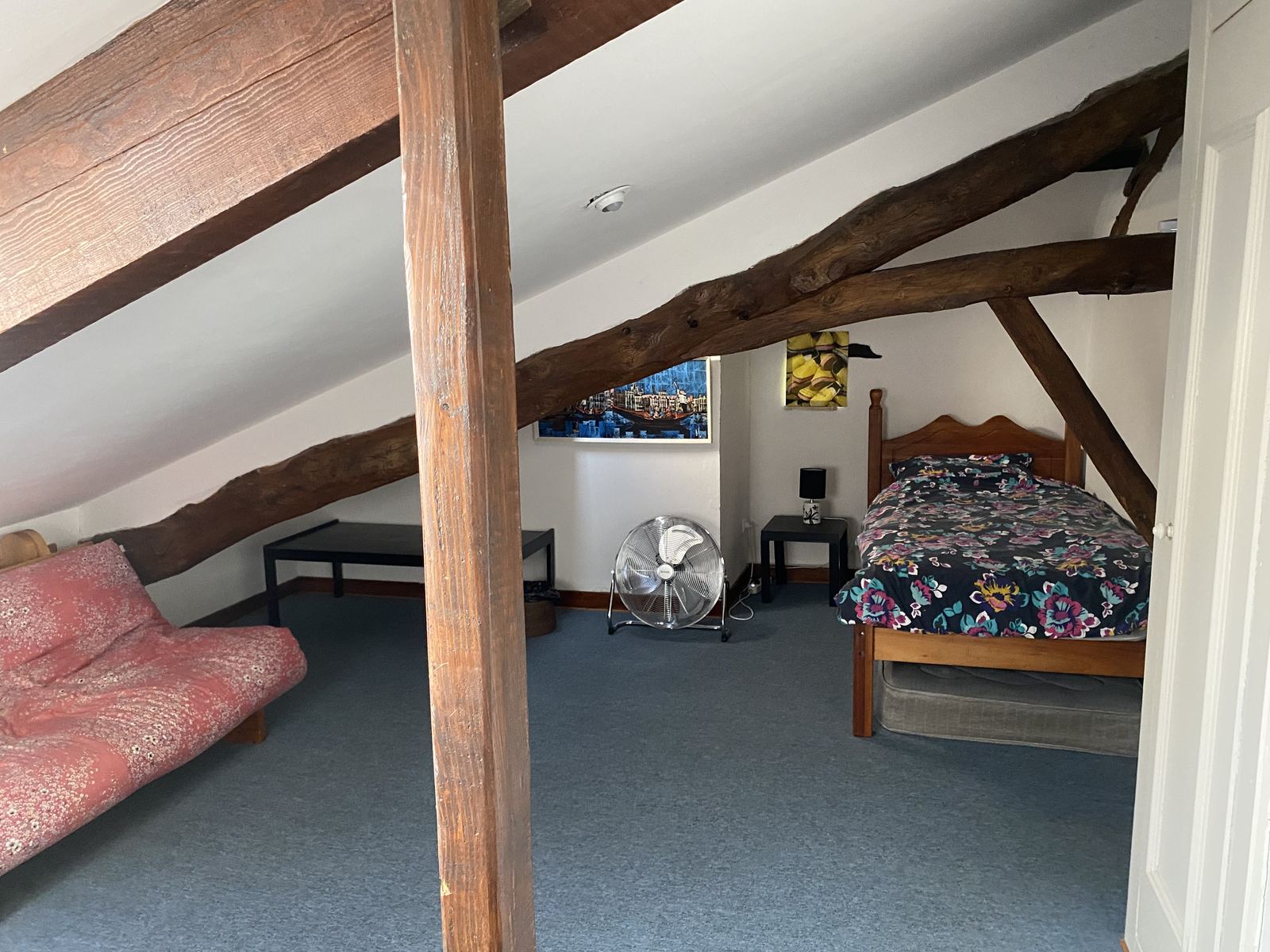 Open-plan attic space with single bed and futon at Mongaudon
